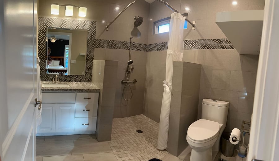 Shower has zero transition. Has small Handicap rails in shower and near toilet.