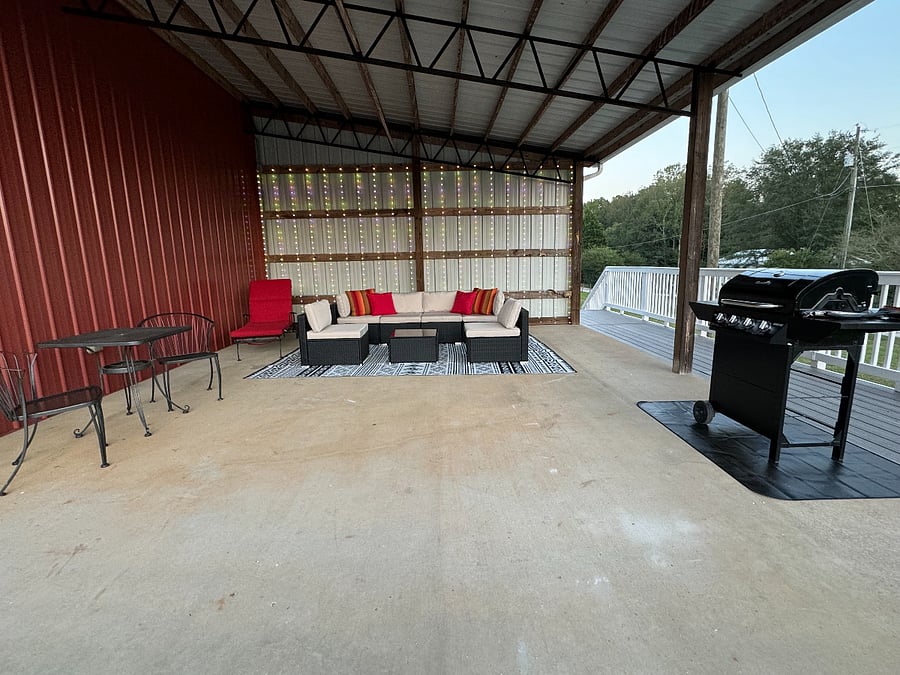 Patio w/ comfortable sofa and chairs, plus grill and table for two