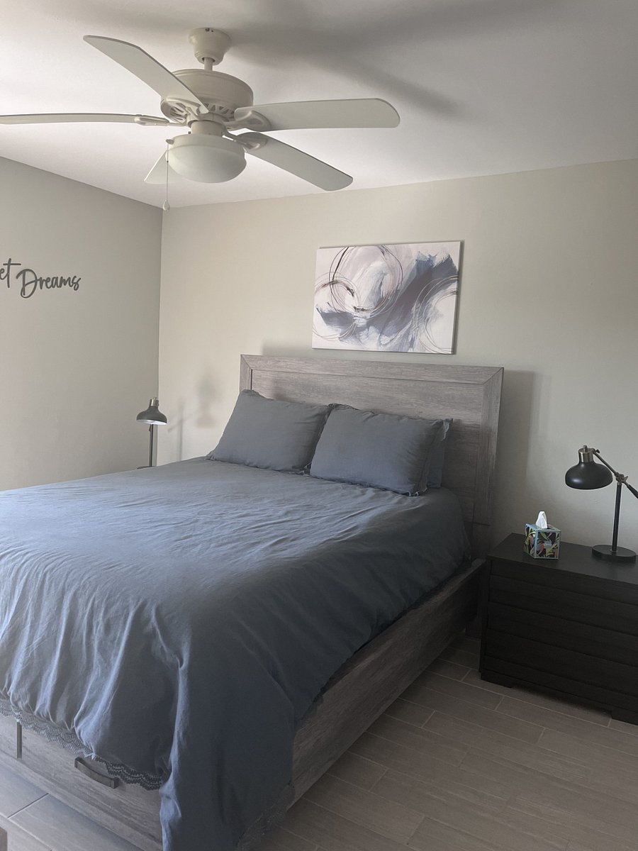 Primary bedroom.  Queen-sized bed.  Patio door opens to screened-in lanai off of the primary.