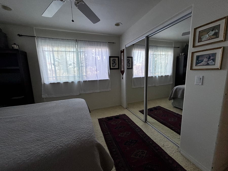 Large closet with mirrored doors in the bedroom.