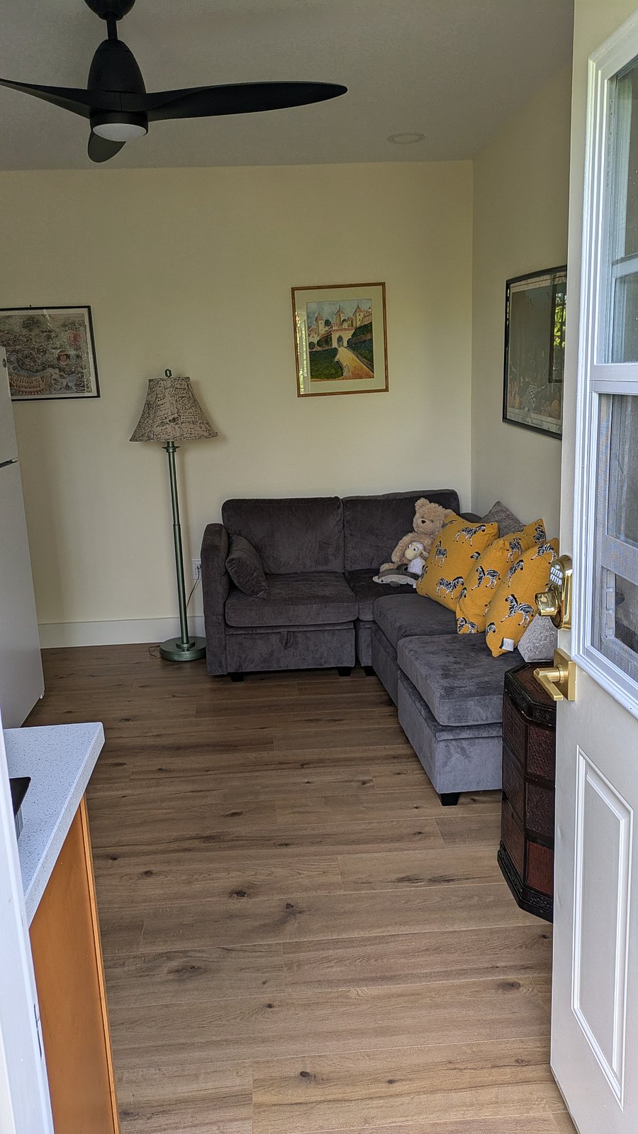 Sectional couch that can be rearranged as needed.  Each sectional has easily accessible storage capacity inside. Ceiling fan.