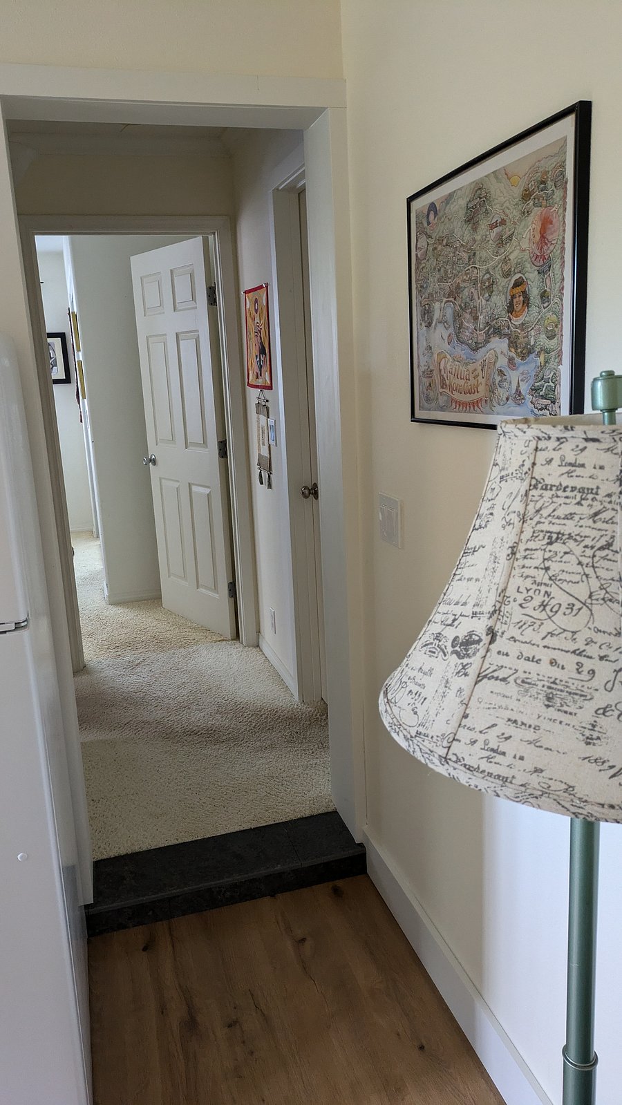 Hallway between bedroom and kitchen/living room. Bathroom on the left before the bedroom, locked door on the right that accesses the landlord's house