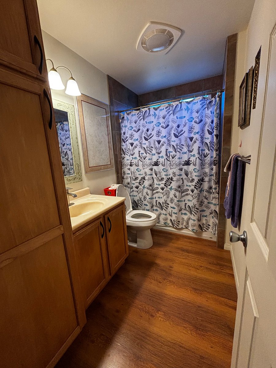 Full bath/shower, large storage cabinet on the left