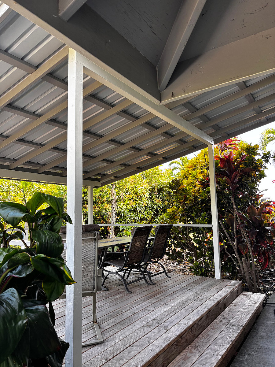 Back lanai with table that seats four and rocker.
