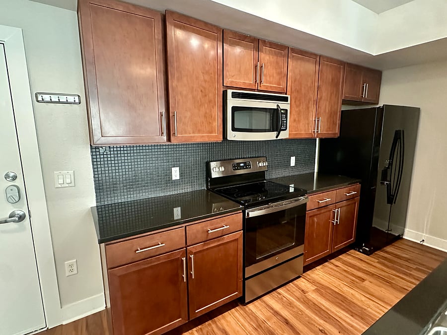 Spacious kitchen with ample counter space. It is stocked with all the essentials, including a Keurig coffee maker, blender, cutting boards, tupperware, glass bowls, baking sheets dishware for 8.