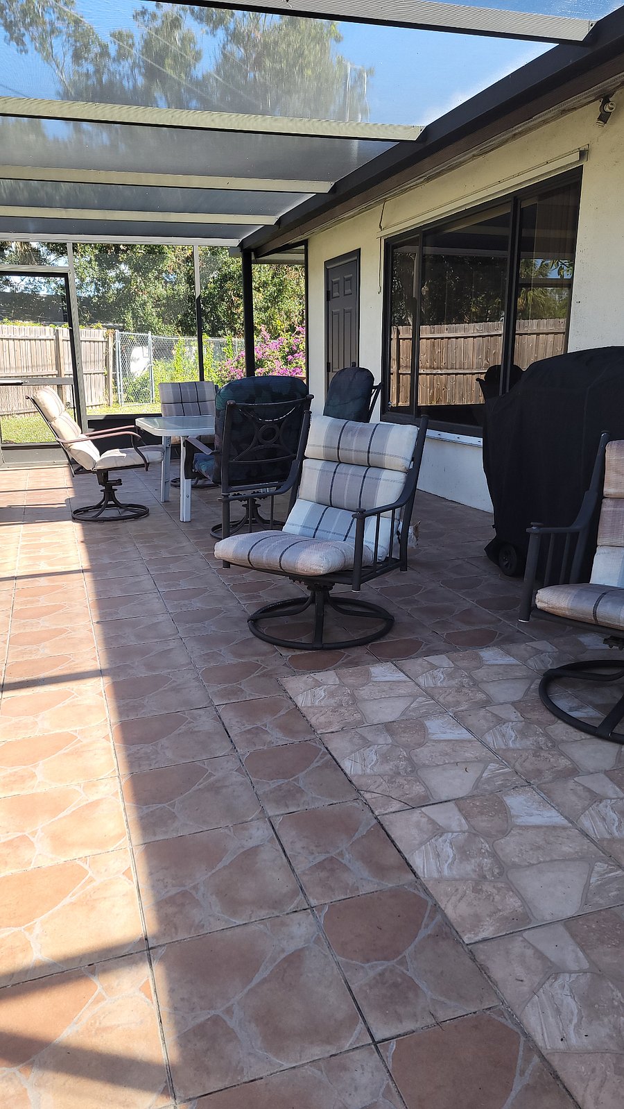 Lanai with table and charis and BBQ grill