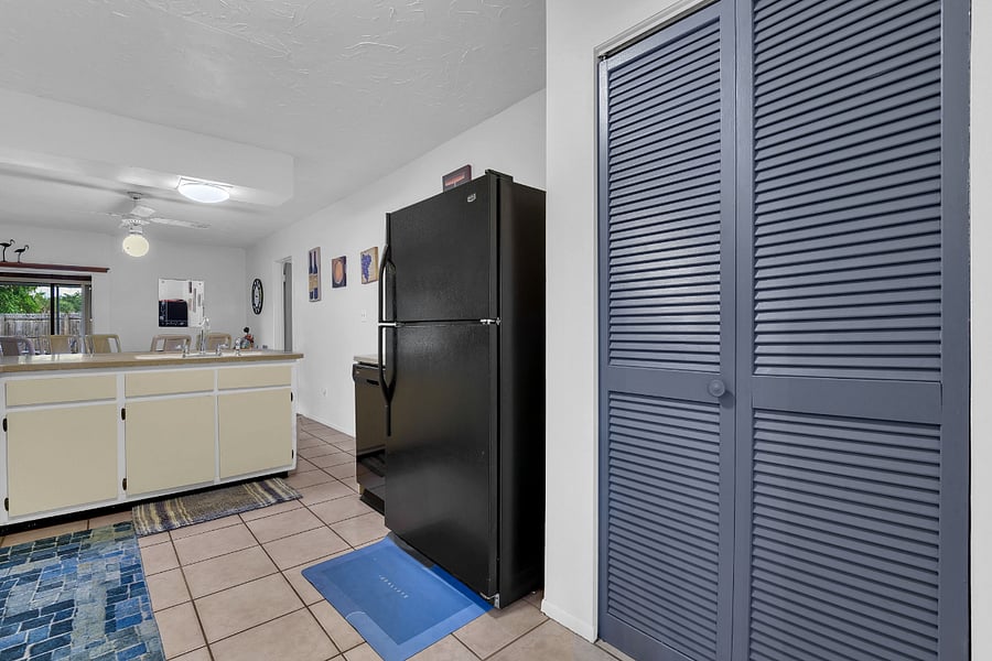 Kitchen featuring pantry, fridge, dishwasher