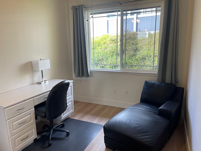 Office with ceiling fan.