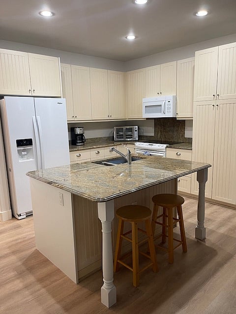 Kitchen with full sized appliances including a new dishwasher.