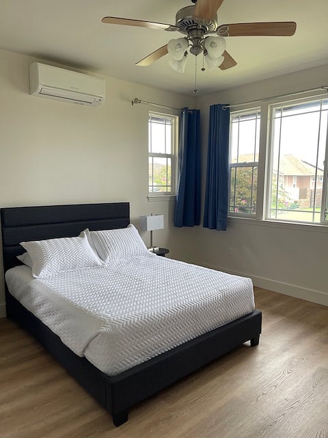 Primary bedroom with AC and ceiling fan.