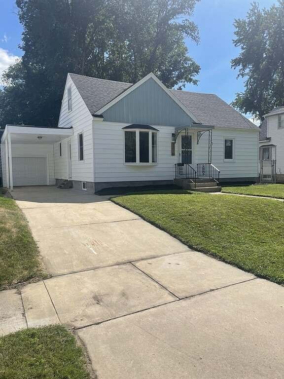 Exterior front of home. Single driveway and free street parking. Backyard (not yet pictured) has a cement patio and a partially fenced in yard.