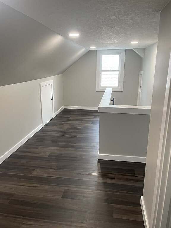 The hallway upstairs leading to the office, half bathroom and third bedroom. Please note the sloped ceilings. The main walkway is approx. 6'7" tall.