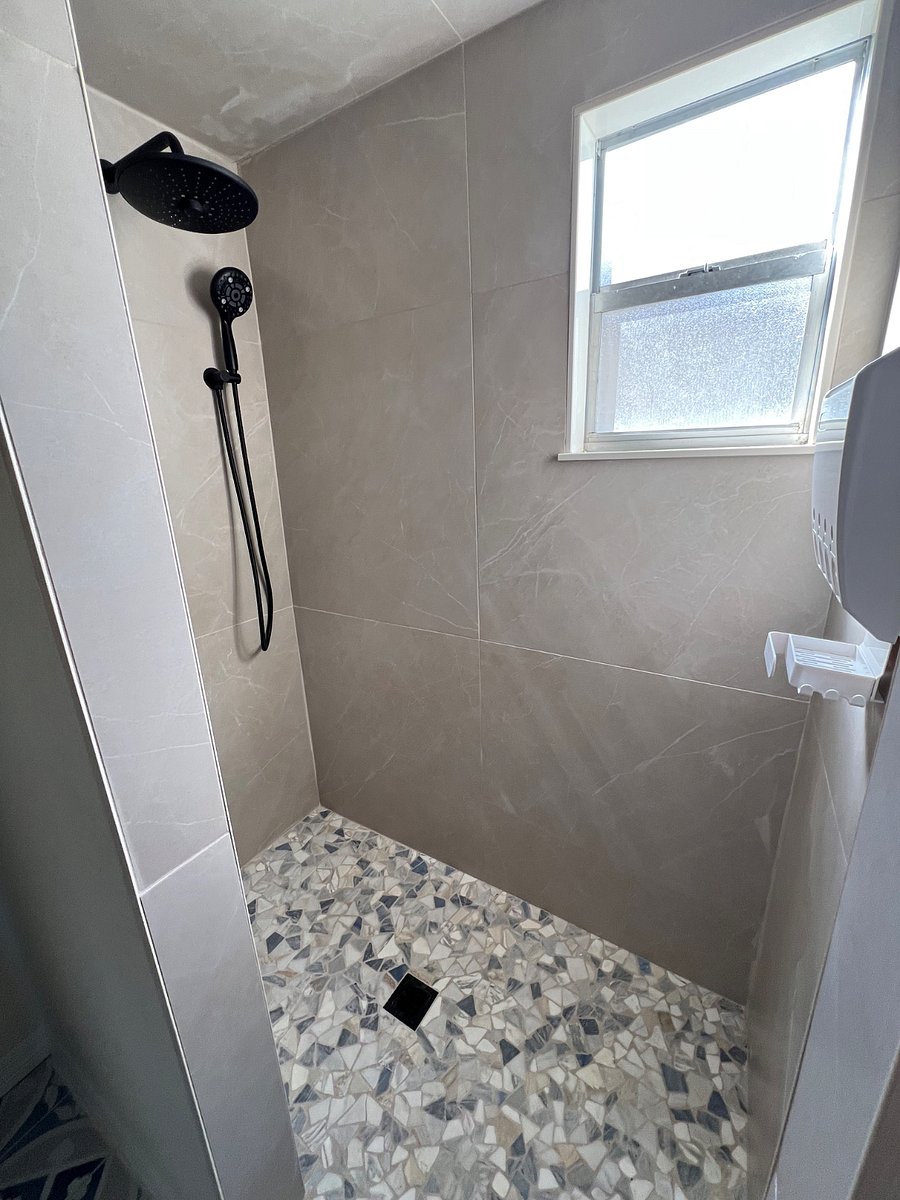 Master Bathroom walk-in shower with shampoo, conditioner, and body wash dispenser. 