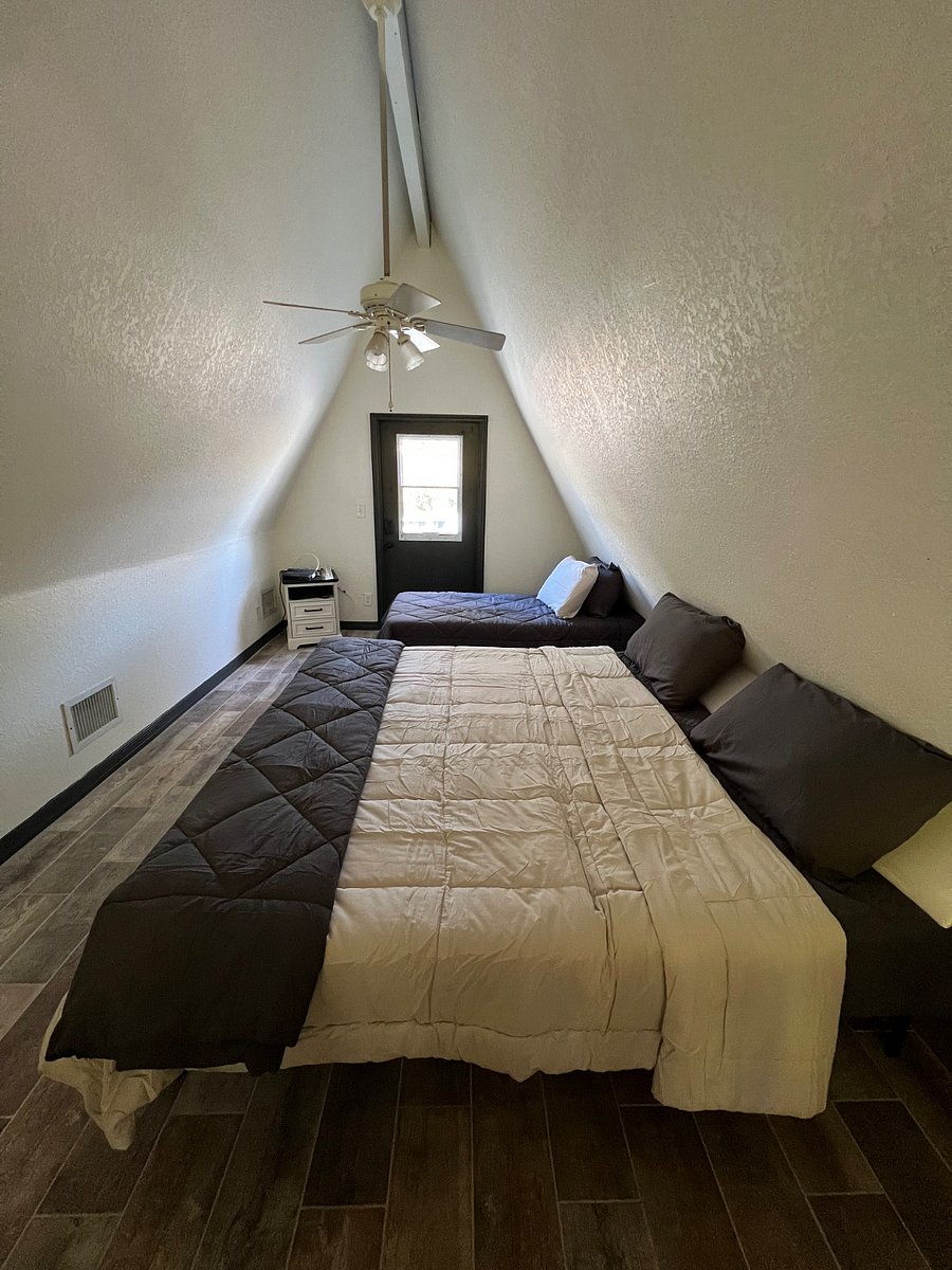 Loft bedroom with king (2 twins) and twin bed.  Also enough room for travel pack-n-play if needed upon request.  Smart TV, clothes rack with hangers, and 4 nightstands with USB connector chargers will be in room for storage. Exit door to a patio with table and 4 chairs.