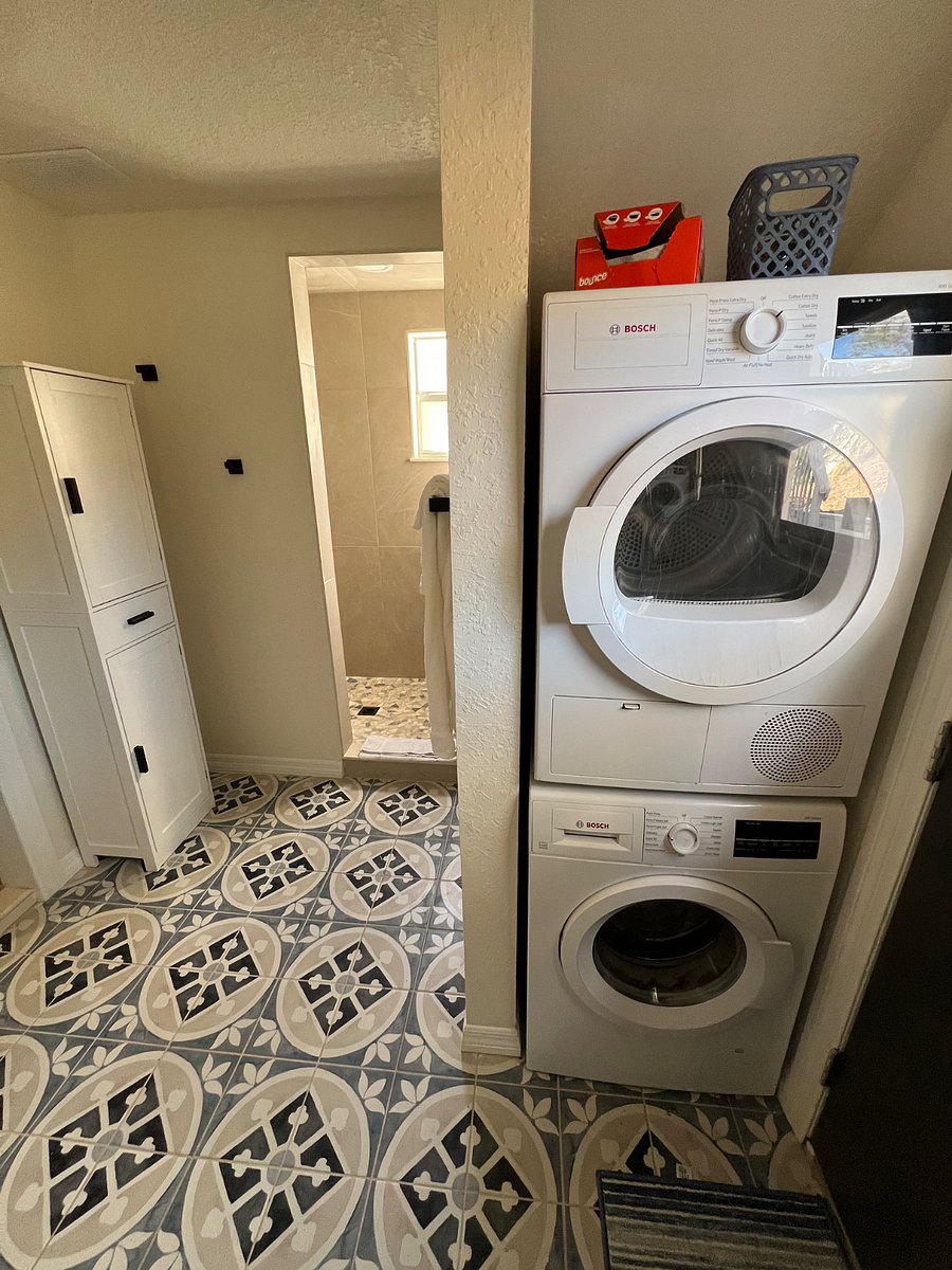 Master Bathroom walk-in shower, storage cabinet, and washer/dryer.  Exit door located in bathroom.