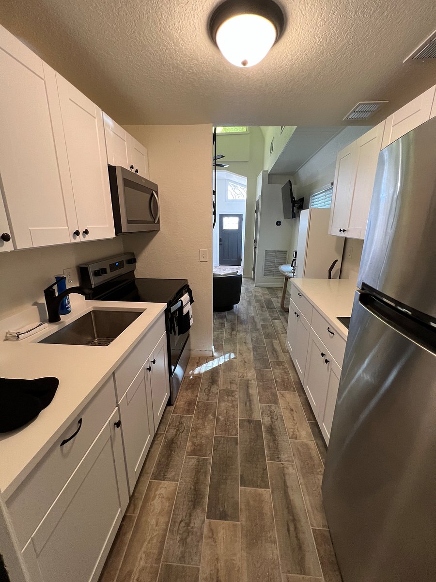 Kitchen has full refrigerator, pots and pans, silverware, plates, glasses, mixing bowls, air fryer, toaster, utensils, and so much more.  Extra cabinets for your food or storage. Electric broom and manual broom/dust pan.