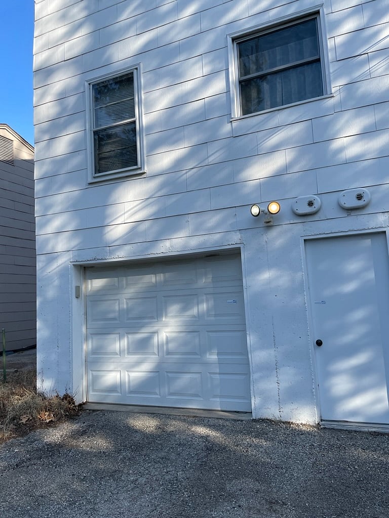 Garage entrance and additional parking space in driveway