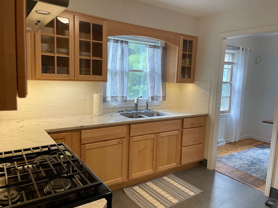 Stone counter tops and window overlooking backyard
