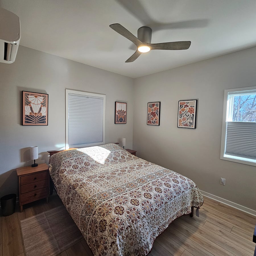 Queen bed with brand new mattress. Blackout blinds. Two nights stands with storage space and lamps. Linens, comforters, pillows and body pillow provided. Closet and dresser