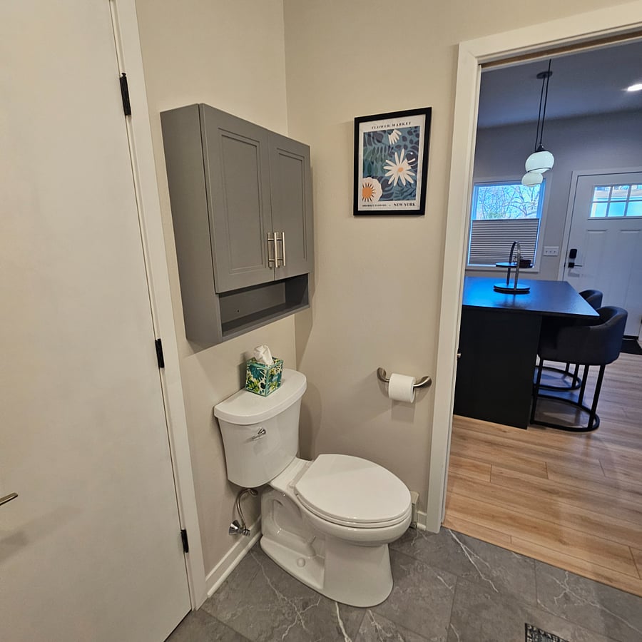 Towels, cleaning supplies and plenty of bathroom storage. Kohler toilet