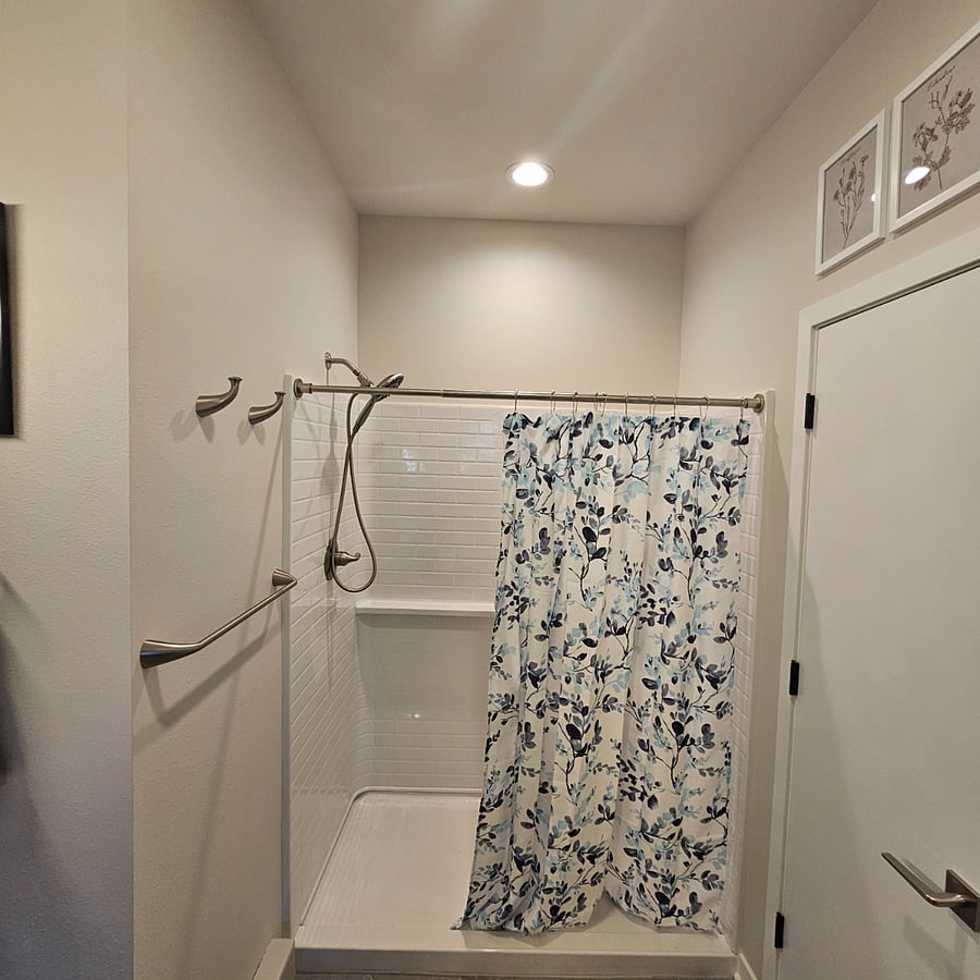 Walk in shower with detachable hand held shower head.