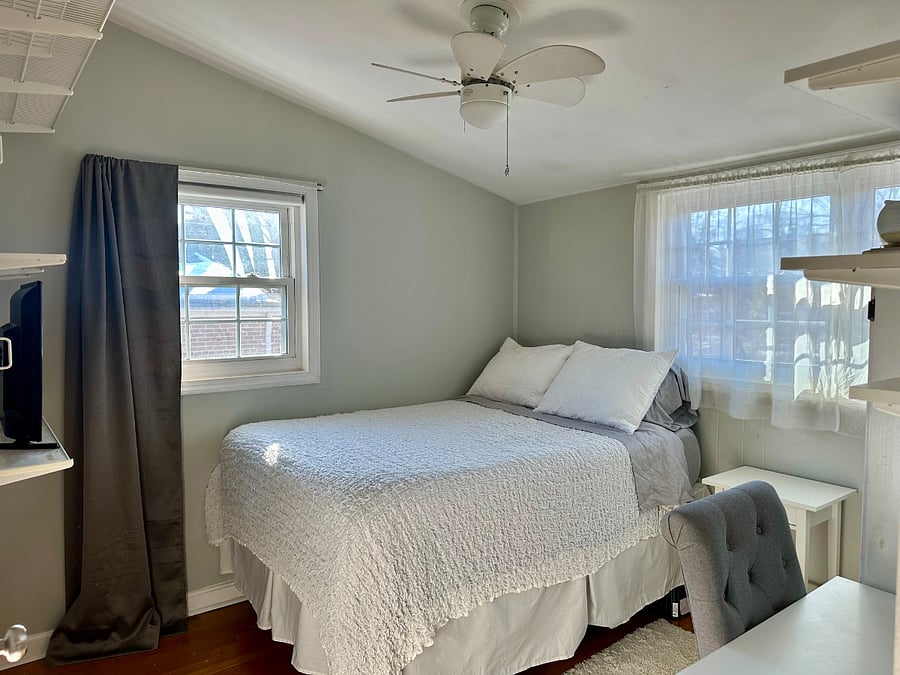 Guest bedroom with double bed, chest of drawers, shelving, nightstand, blackout shades, lamp has been added).
