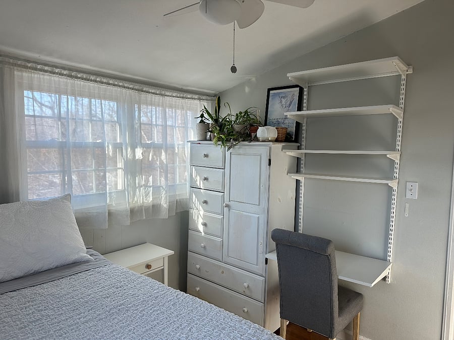 Guest bedroom, chest of drawers, laptop station.