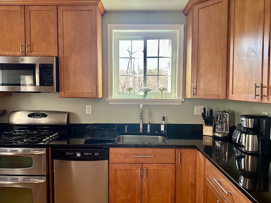 Fully equipped kitchen on main level with living room, dining room, and half bath.