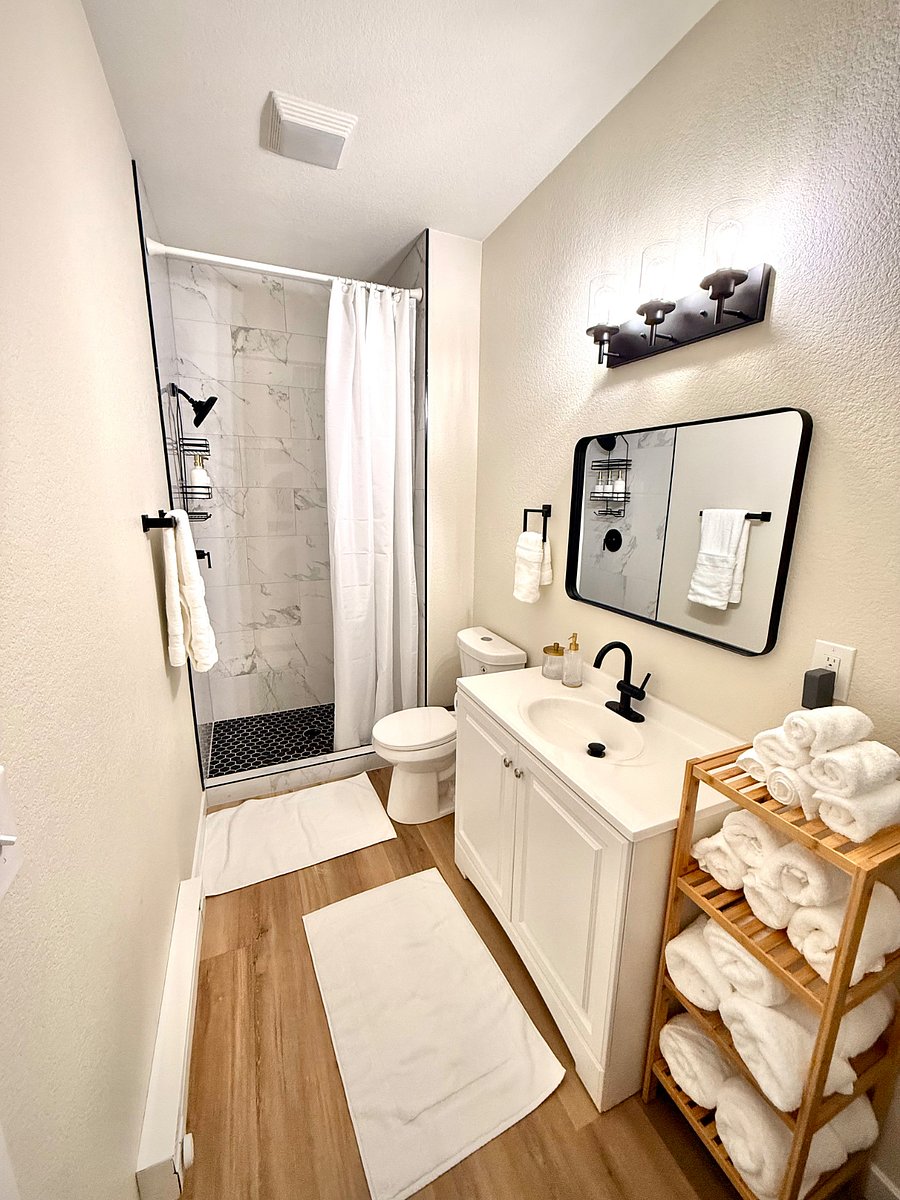 Modern Walk In Shower, stocked with Shampoo, Conditioner, BodyWash, and cleaning Supplies