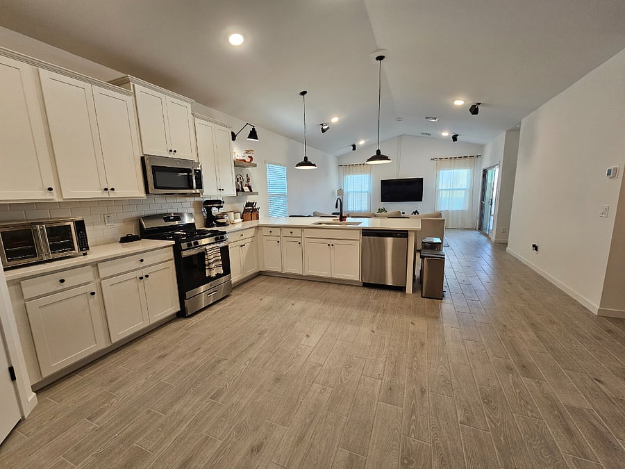 Kitchen with full cookware and diningware.