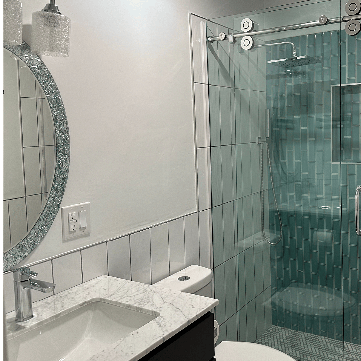 Upstairs full bath with walk-in shower and glass shower doors.