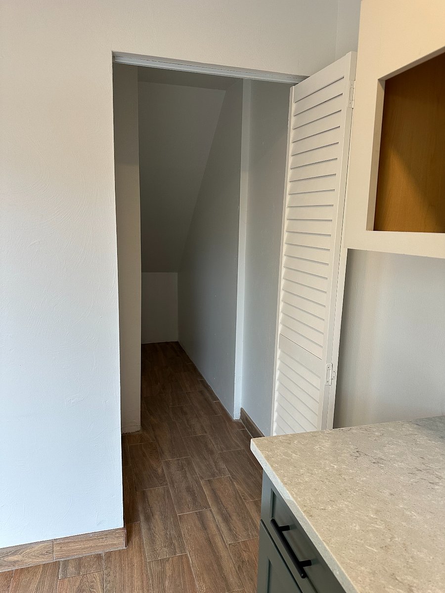 Large under-stairs walk-in storage for bicycles.