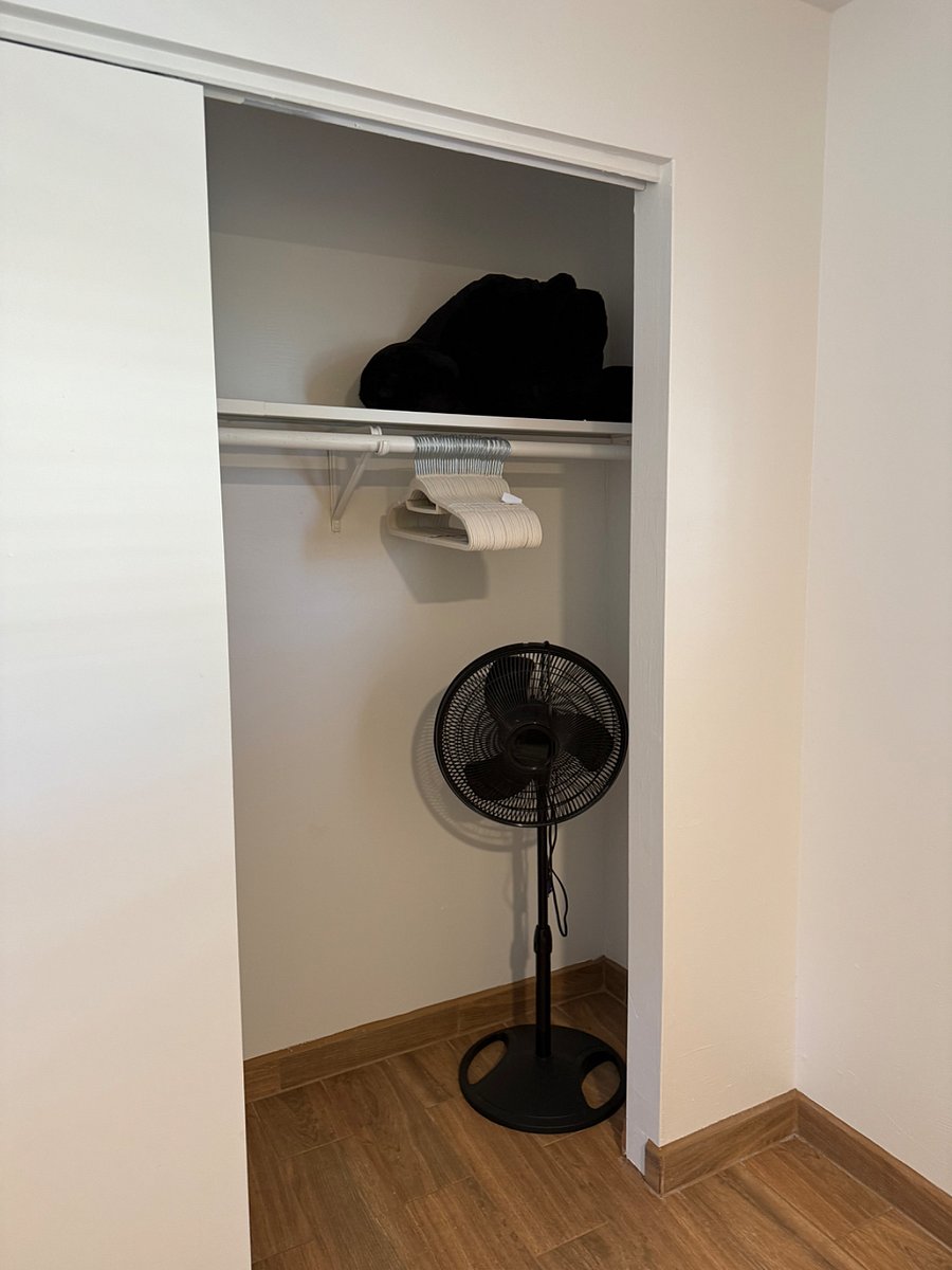 Standing fan and clothes hangers.