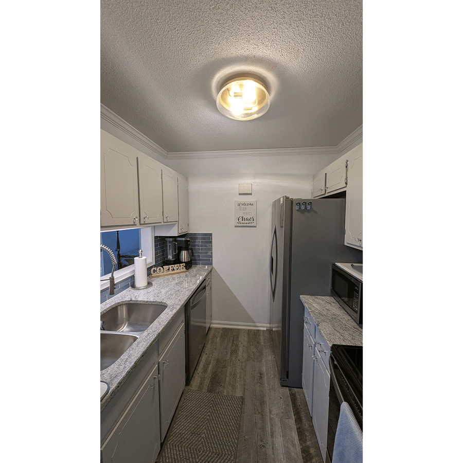 Galley style kitchen with stainless steel appliances