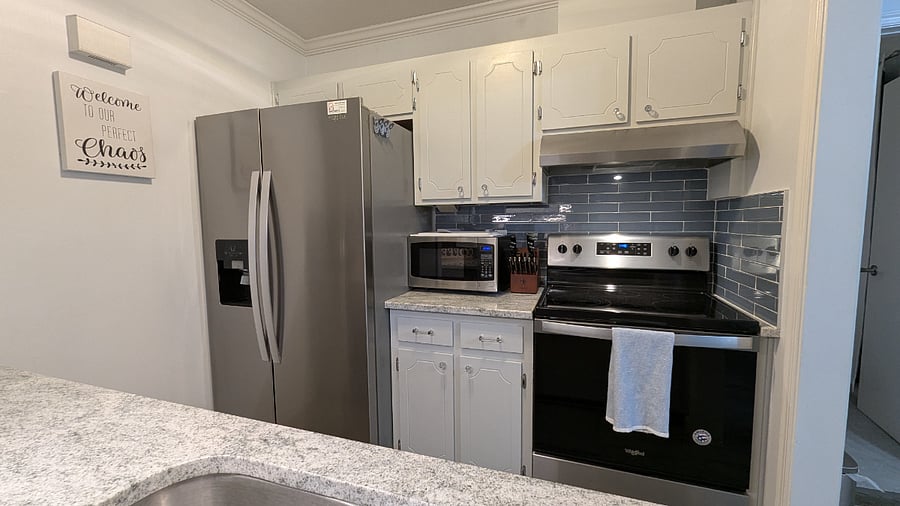 Kitchen with attractive blue glass subway tile backsplash 