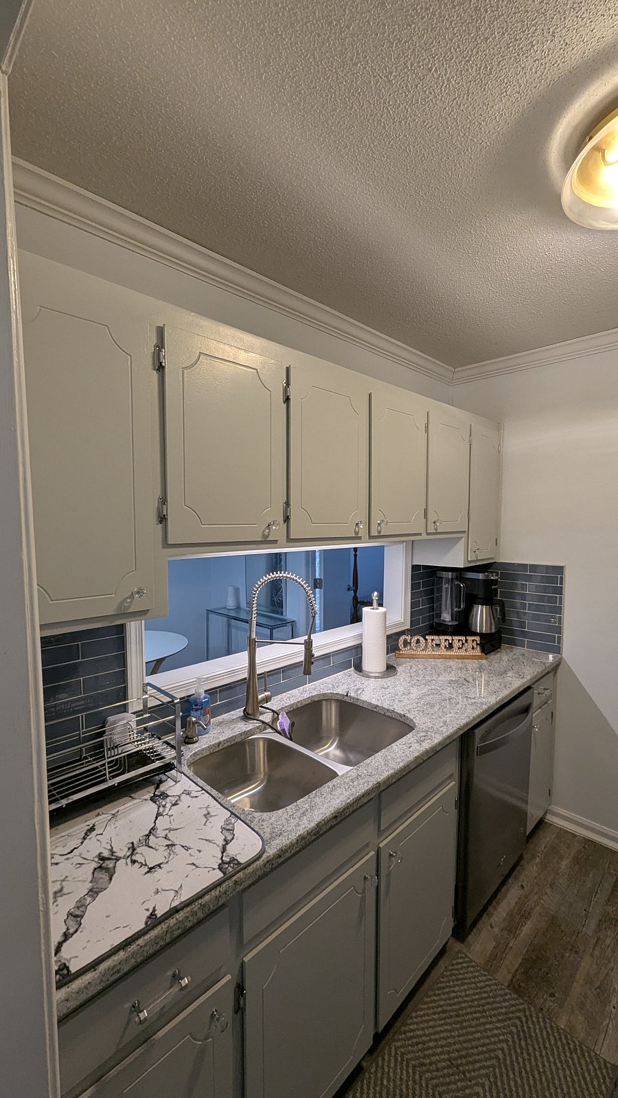 Kitchen with double stainless steel sink, with modern appliances and fixtures and granite countertops