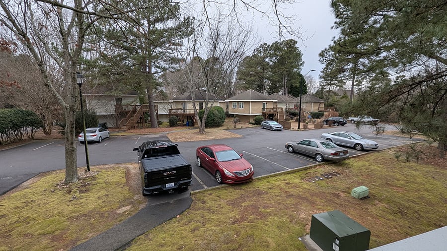 Parking and a picture across the parking lot.  Your designated parking space is where the black truck is parked, immediately at the end of the walkway which leads to the unit.  (Picture taken during the day.)