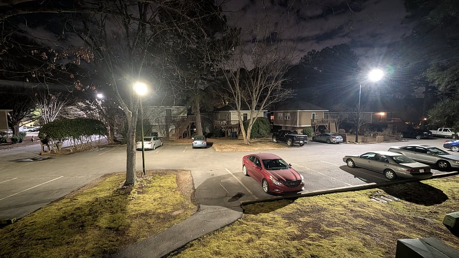 Well lit parking - looking from the balcony onto the parking lot in front of the unit (Your designated parking space is the empty spot at the end of the walkway, and beside and to the left of, the red car and under the light.)  Picture taken at night.