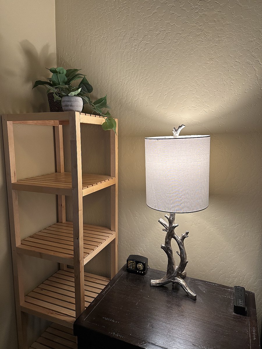 Bedside tables on each side of the bed have power outlets and usb ports