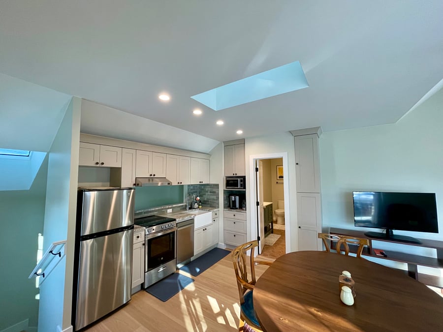 Kitchen with stainless steel appliances, granite countertops, Keurig coffee maker, garbage disposal, moveable island with cutting board