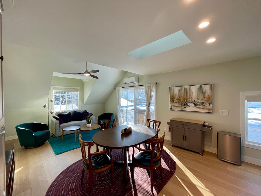 Living room with couch that pulls out into a full bed. Large patio doors, small west facing patio.