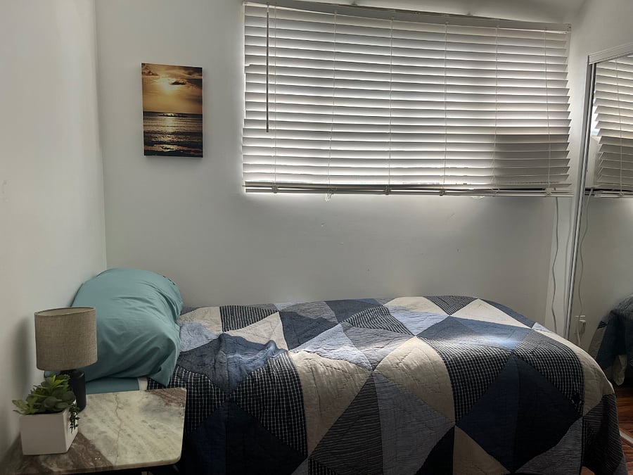 Makai Bedroom/Office with Twin XL bed, desk, office chair and flat screen monitor/TV.