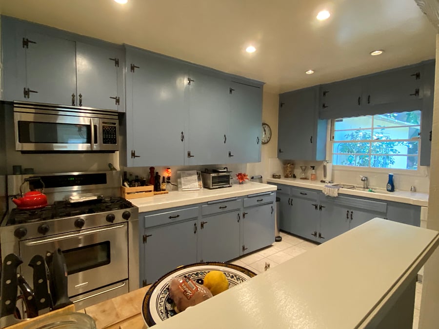 French Styled Kitchen with plenty of cabinets/storage. Laundry room off kitchen by rear door. View to rear yard.