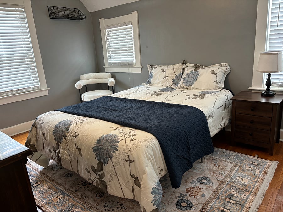 Queen Bed Room Amenities: night stand, lamp, dressing chair, side table, dresser and mirror, closet.