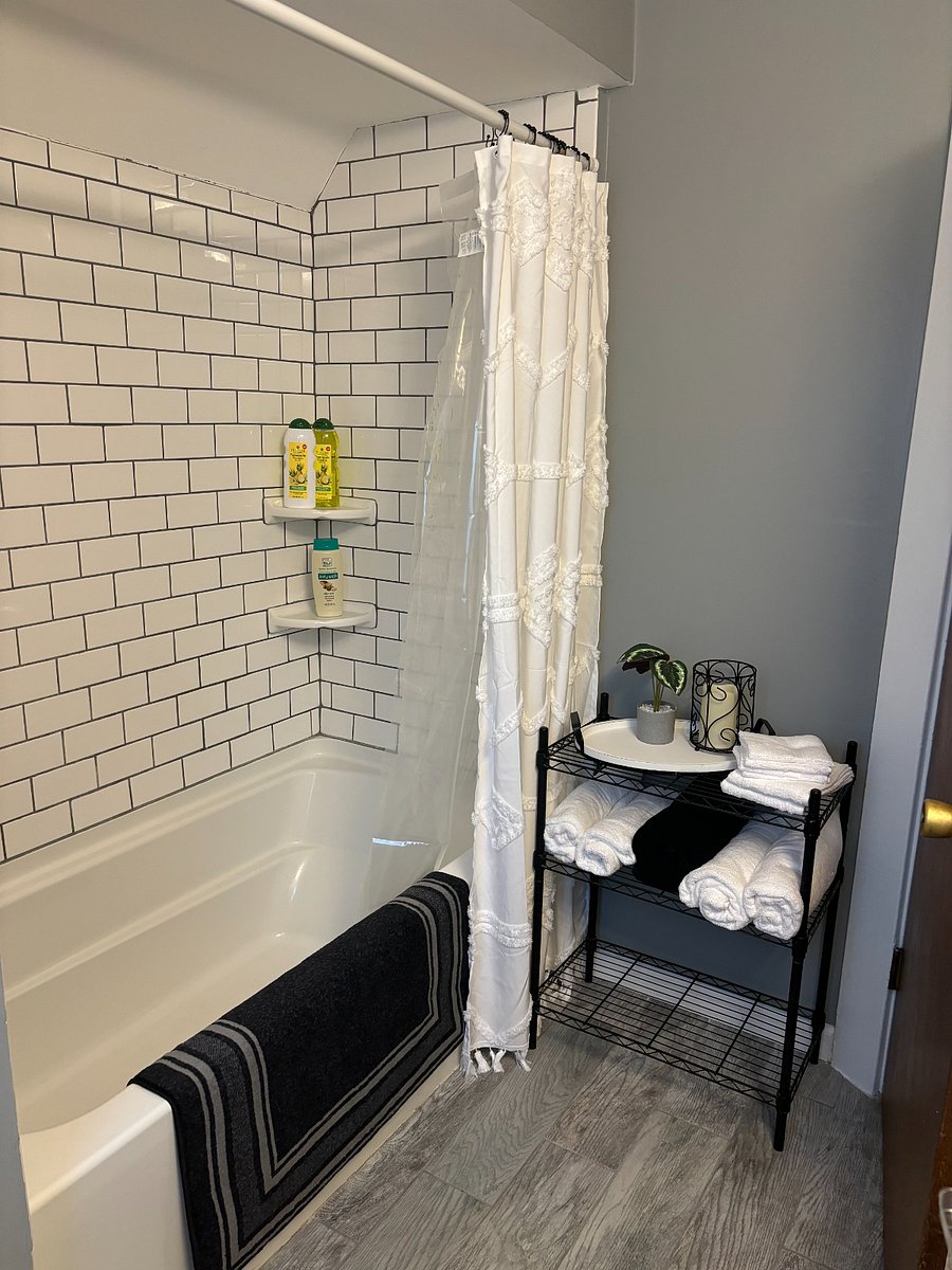 Full Bathroom amenities: Soaking tub and shower with curtain, bath towels & wash cloths, hair dryer, starter soaps & toilet paper.