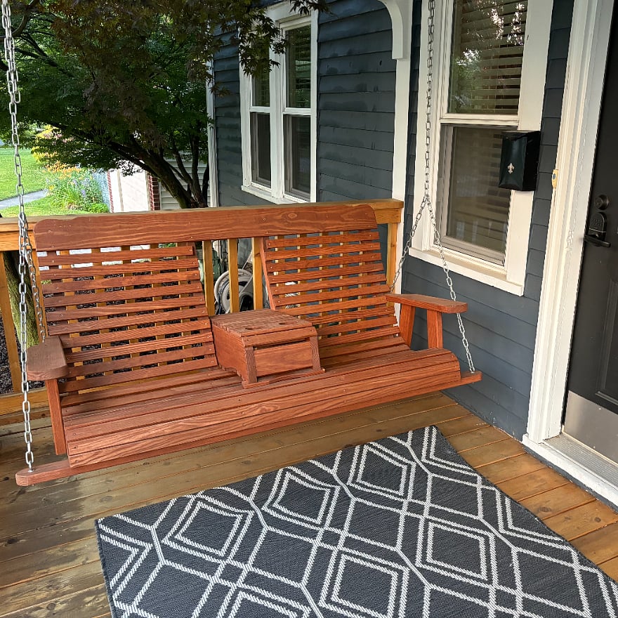 Porch swing is convertable to 3 seats or 2 seats with arm rest/beverage holder.
