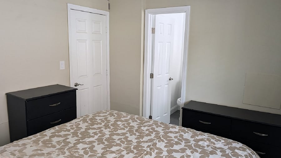 Bedroom left door leads to Livingroom. Open door is bathroom