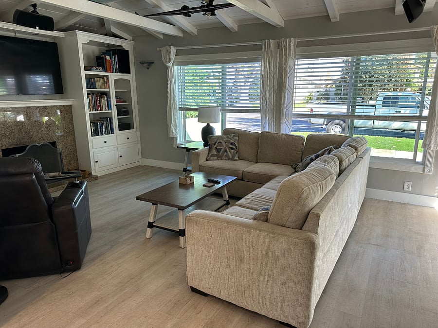 Living room has huge bay windows. Allows natural light from the East.