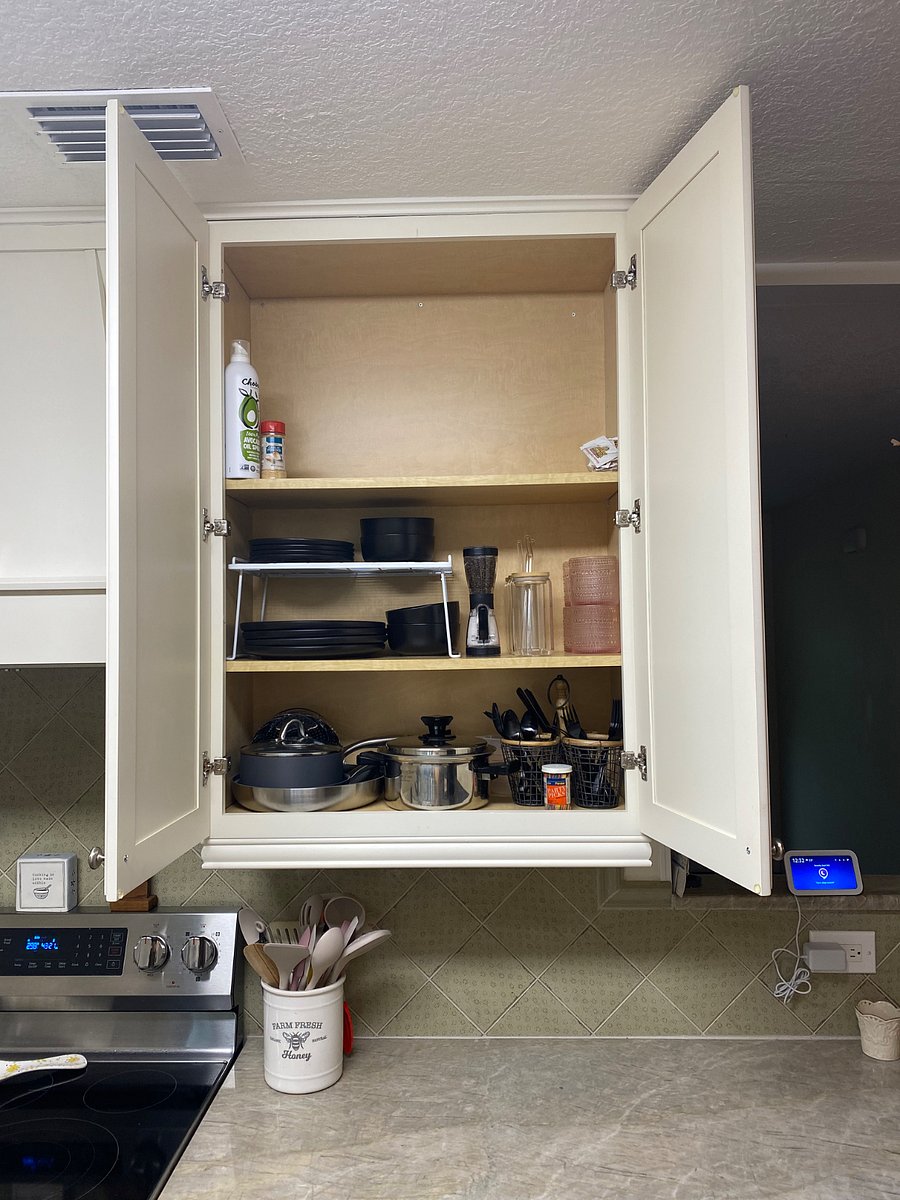 Private kitchen cabinet space with pots, pans, silverware, glasses etc..