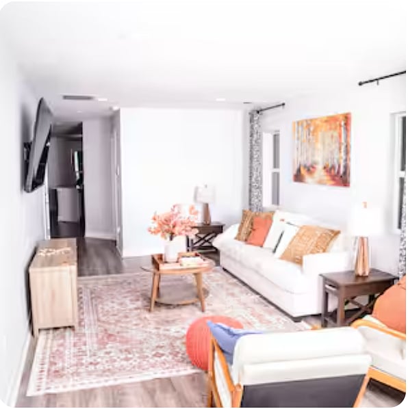 View from front door entry into spacious living room and onward to open floor layout with kitchen, dining, and entertainment areas.